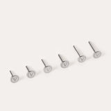 Six silver metal pins—Push-Pin Titanium Flatback Replacement Backings—are arranged in a row on a light background. Each flat circular top is engraved with a V symbol, highlighting the sleek craftsmanship of Vanchi titanium.