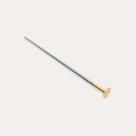 The Vanchi Labret Piercing Taper Care Set features a long, slender metal taper with a gold-toned circular end, displayed diagonally on a plain white background.