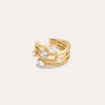 The Vale Crystal Ear Cuff in Gold features three parallel gold bands with clear gemstones and a “925” stamp inside, indicating sterling silver beneath the gold finish. Perfect for adding sparkle to your ear stack.