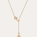 Gold necklace with a unique pendant on a light beige background