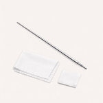 The Vanchi Labret Piercing Taper Care Set, featuring a metal taper with textured grip, is shown above a folded white cloth and small square pad on a light surface.