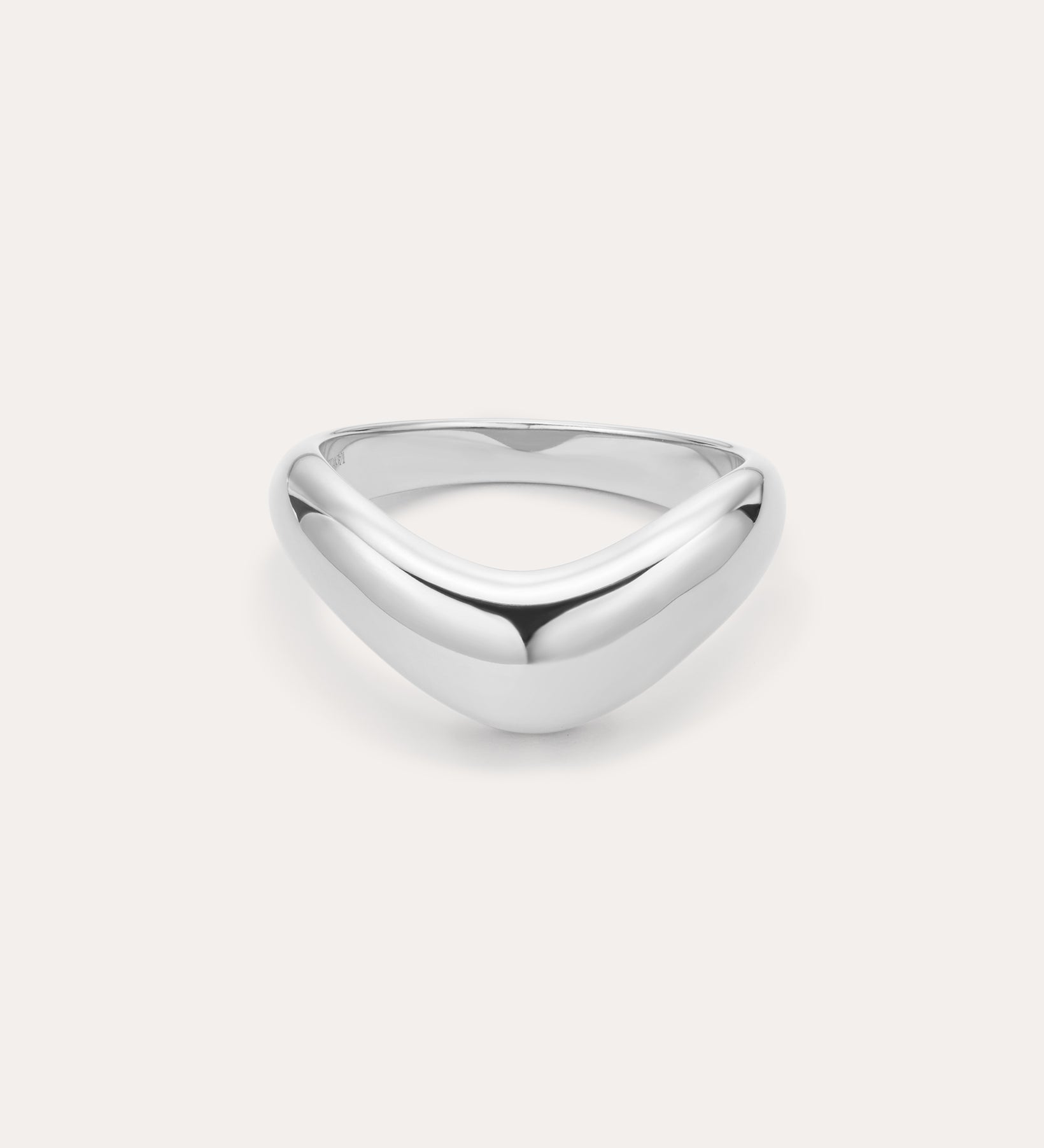 The Vava Plain Chunky Curved Wave Ring in Silver features a polished, silver V-shaped wave design with a smooth, rounded surface. Photographed against a light background, its ideal for minimalist jewelry lovers.