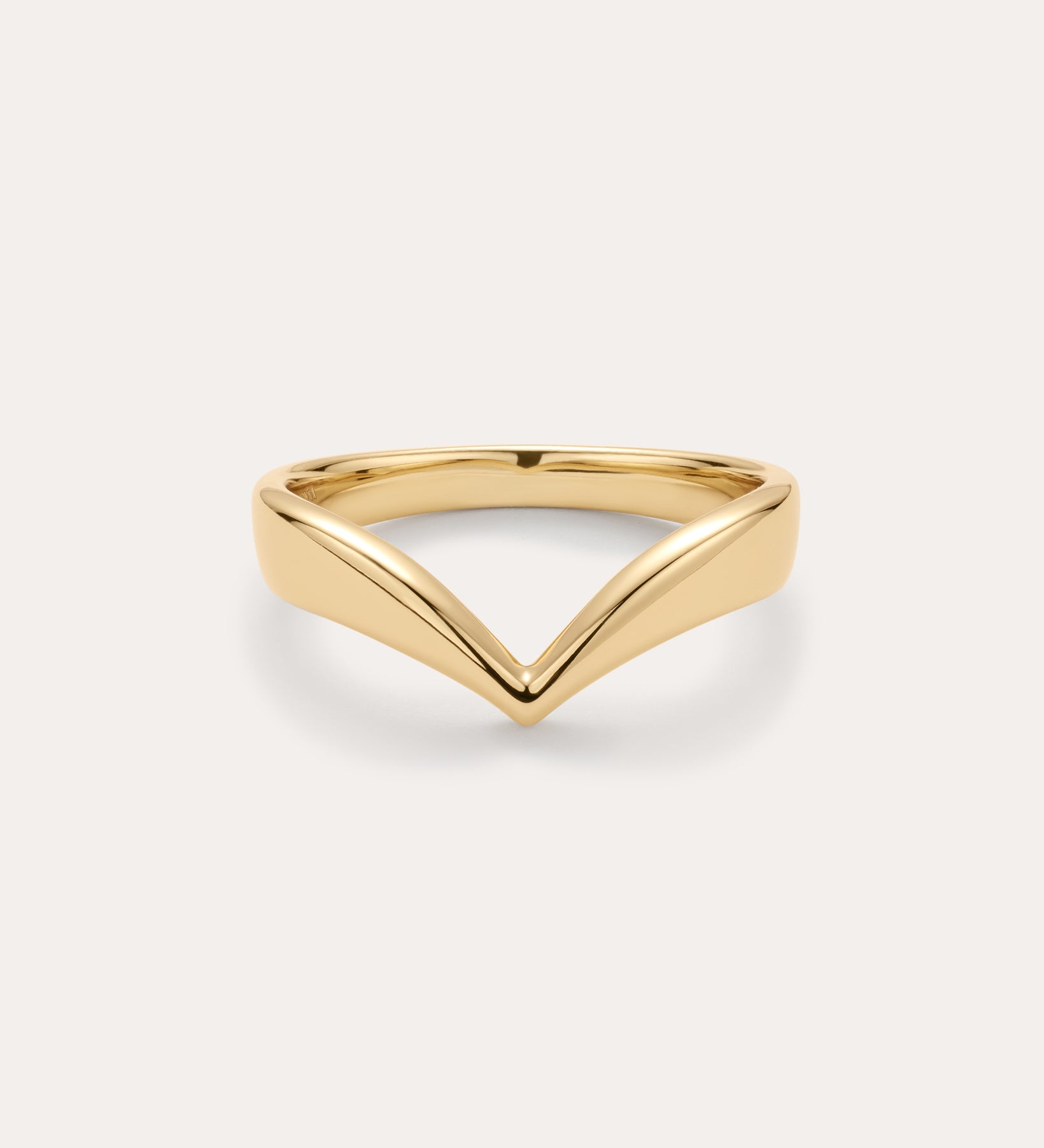 The Veda Plain Chevron Ring in Gold is a minimalist, gold-plated wishbone ring with a sleek V-shaped design, shown against a simple light background.
