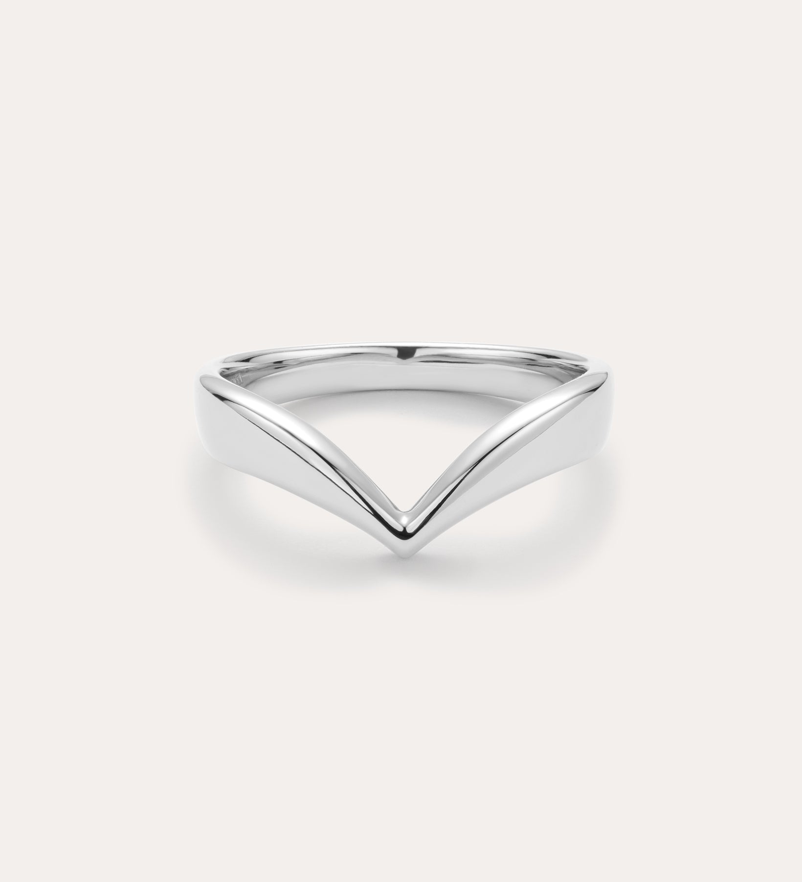 The Veda Plain Chevron Ring in Silver features a minimalist, V-shaped sterling silver design, showcased against a simple light background.