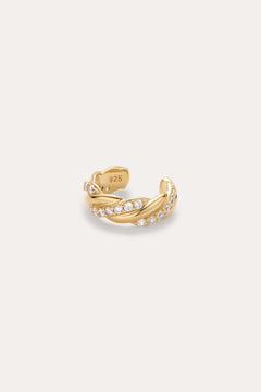 The Vera Twisted Crystal Ear Cuff in Gold, featuring two intertwined rows of small clear crystals and a “925” stamp inside the band, is shown against a plain light background.