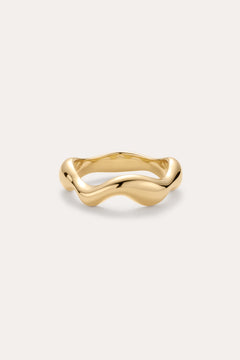 The Vica Fluid Wave Chunky Band Ring in Gold features a bold, wavy band design and is displayed on a simple, light background.
