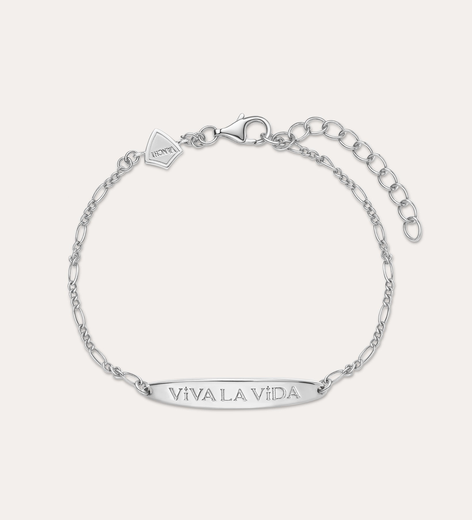 The Viva La Vida Bar Chain Bracelet in Silver features an adjustable Figaro chain, a rectangular plate engraved with VIVA LA VIDA, and a small embossed logo tag. Pair it with our Viva La Vida necklace for a matching set.