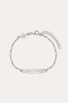 The Viva La Vida Bar Chain Bracelet in Silver features an adjustable Figaro chain, a rectangular plate engraved with VIVA LA VIDA, and a small embossed logo tag. Pair it with our Viva La Vida necklace for a matching set.